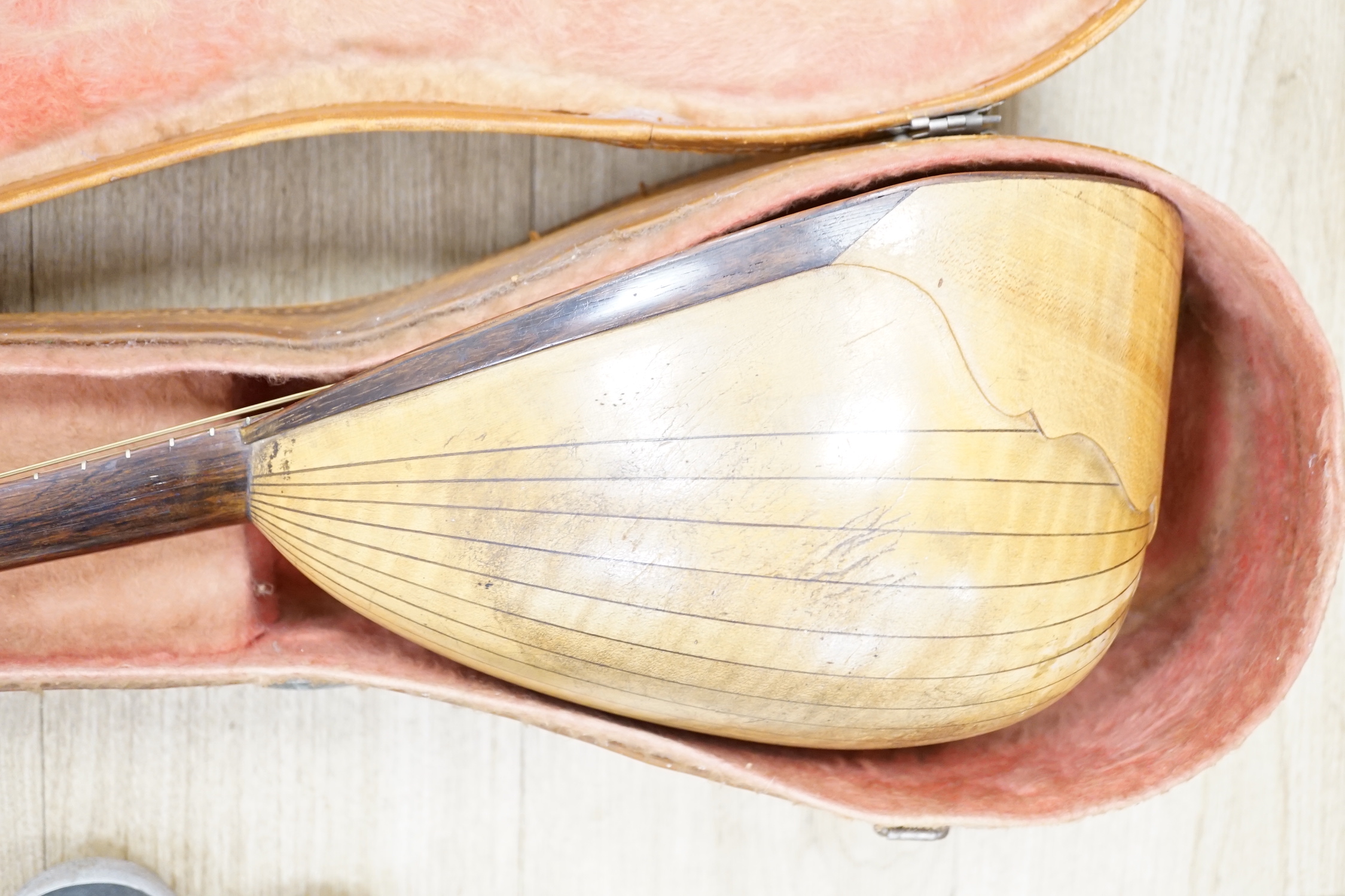 A cased Italian mandolin, labelled Domenico Maratea, and Fratelli Vinaccia, Naples, bowl backed body, length of body 30cm, with some packeted spare strings